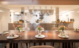 An intimate dining table beside an open kitchen