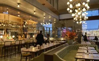 A grand hotel dining room with warm lighting at Lutyens Grill
