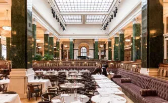 A warmly lit dining room prepared for service