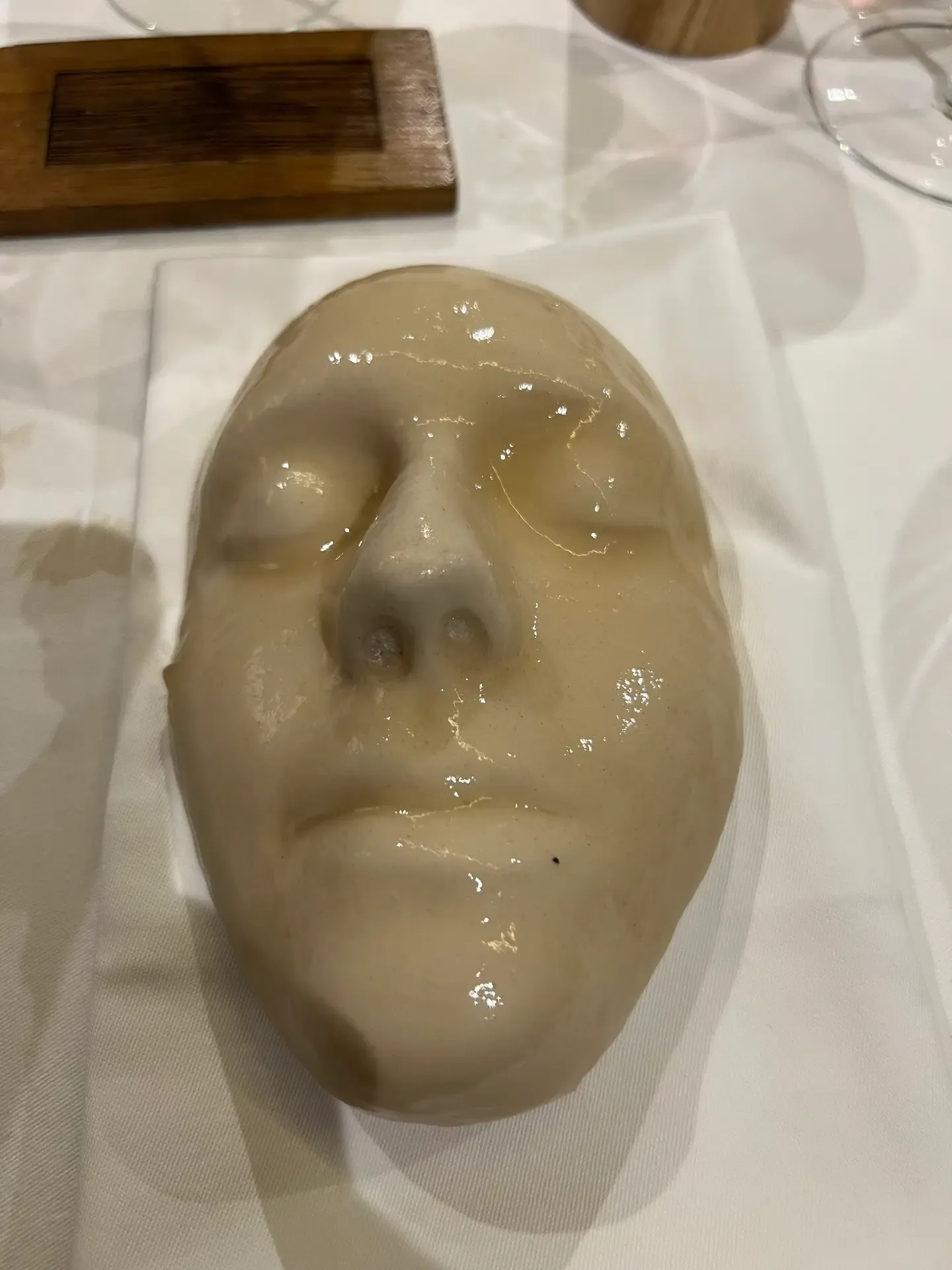 A lifelike cream-coloured face-shaped dessert at Mugaritz